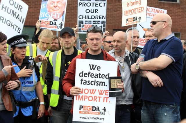 Members of the Pegida group staged a silent protest march through the streets of Rotherham over the town's abuse scandal. The founder of the group ex EDL leader Tommy Robinson pictured centre.