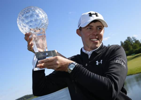 Matthew Fitzpatrick poses for photographers with the trophy after winning the Nordea Masters golf tournament at the Bro Hof golf club, Stockholm