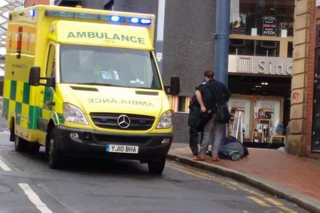 Paramedics attend to a street drinker near West Street in Sheffield city centre. Residents claim people getting drunk and high on drugs are ruining the area as plans for a third off-licence goes to Sheffield Council planning committee - Photo: Sheffield City Centre Residents' Action Group