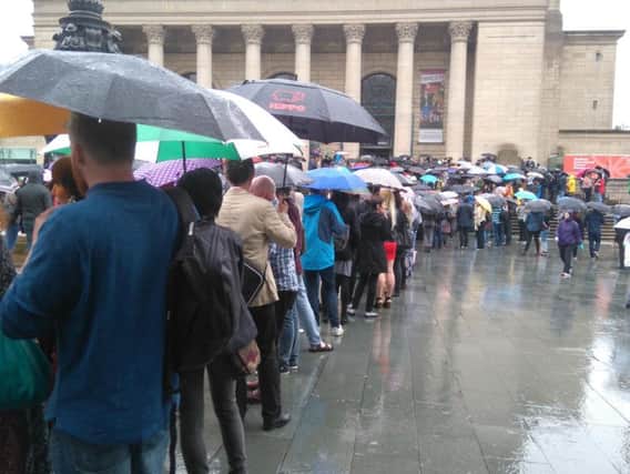 Long queues waiting in the rain to get into Sheffield City Hall after a fire alert delayed the start of Michael Moore's new film being screened at the opening of Sheffield Doc/Fest