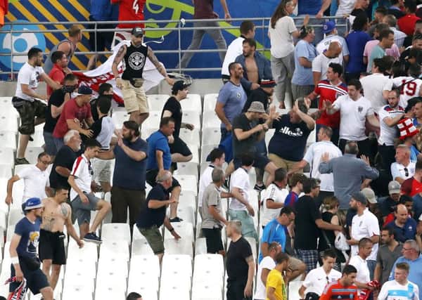 Tempers flare between rival fans in the stands during the UEFA Euro 2016, Group B match at the Stade Velodrome, Marseille. Photo: Owen Humphreys/PA Wire.