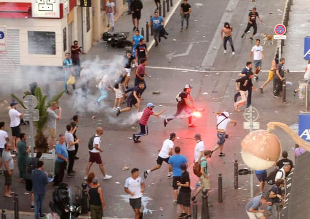 A fan runs with a flare ahead of the England vs Russia France Euro 2016 match, in Marseille, France. Photo: Niall Carson/PA Wire