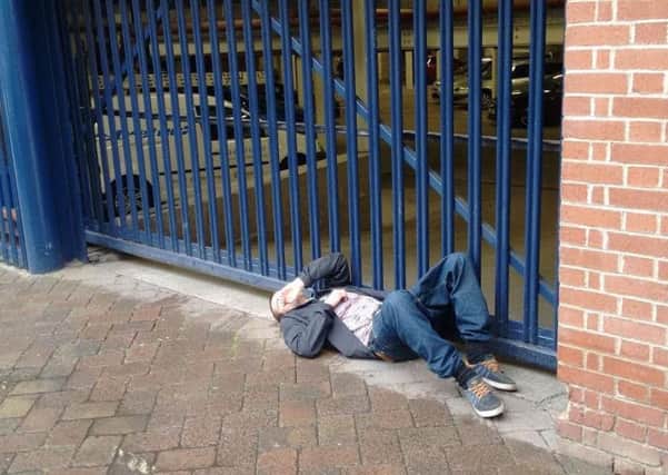 A man passed out on the pavement outside flats on Glossop Road, Sheffield city centre. Residents claim people getting drunk and high on drugs are ruining the area as plans for a third off-licence goes to Sheffield Council planning committee - Photo: Sheffield City Centre Residents' Action Group