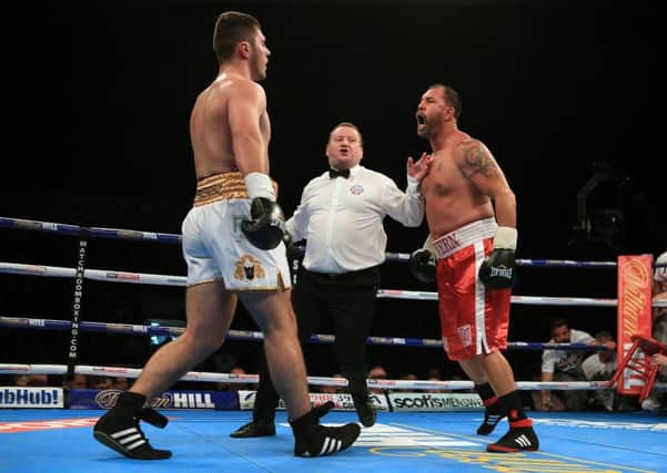 Jason Gavern shouts towards David Allen (left) as ref Howard Foster steps in during the Heavyweight Contest at Sheffield Arena.