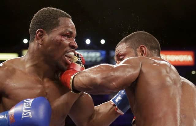 Shawn Porter, left, gets hit by Kell Brook, during their IBF welterweight title boxing bout Saturday, Aug. 16, 2014, in Carson, Calif. (AP Photo/Chris Carlson)