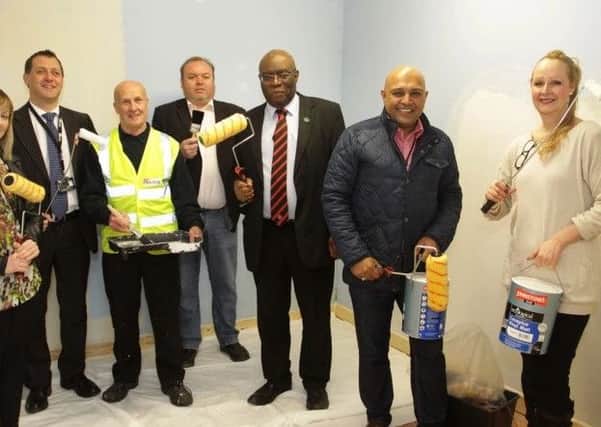 Residents adding a lick of paint to The Link recently. Helen Eadon is pictured on the far right.