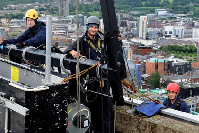 (l-r) Jamie Needham, Adam Lindley and Katie Palling prepare to abseil down the Arts Tower and clean the windows. Picture: Andrew Roe
