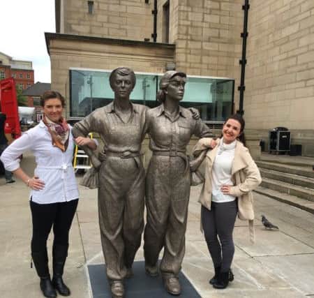 The Star's sales reps Charlotte Young and Emma Toogood with the Women of Steel statue