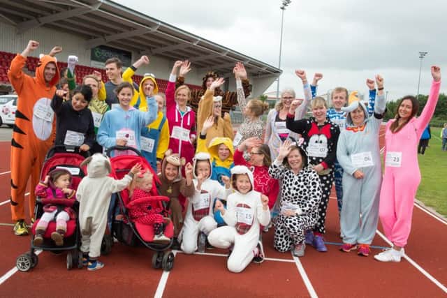 The Onsie Fun Run gets underway at the Keepmoat Stadium Athletics track in Doncaster