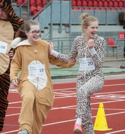 The Onsie Fun Run gets underway at theKeepmoat Stadium Athletics track in Doncaster