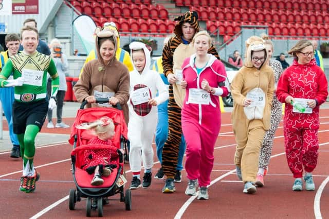 The Onsie Fun Run gets underway at theKeepmoat Stadium Athletics track in Doncaster