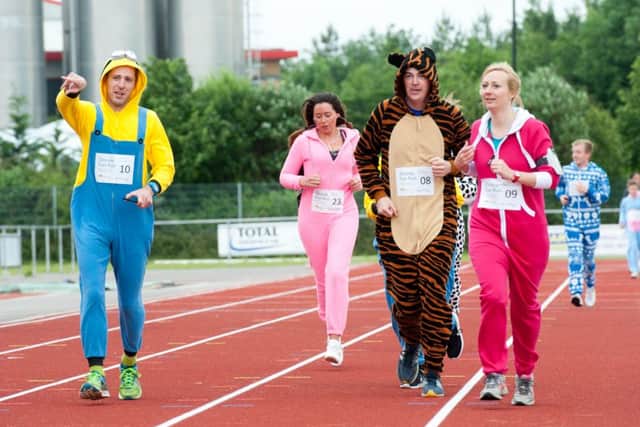 The Onsie Fun Run gets underway at theKeepmoat Stadium Athletics track in Doncaster