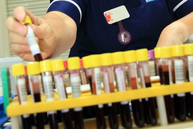 Stock Blood donation session. supervisor processing the blood.