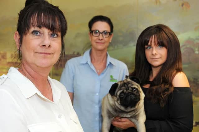 Debbie Newton, left, with her daugter Jodie Elliott, right, and sister Ali Newton, centre, and Adam's pet Pug Finley. Picture by Anne Shelley.