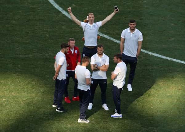 England's Joe Hart with a toy lion on his back alongside team mates during a stadium walkaround at the Stade de Nice, Nice. PRESS ASSOCIATION Photo.