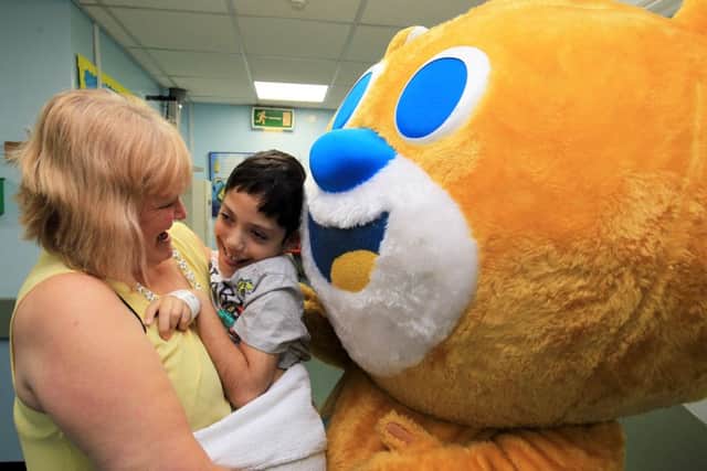 Bake it Better Day at Sheffield Children's Hospital with Howard Middleton a former contestant from the Great British Bake Off. Denise Singheyley and patient Theo, nine, make friends with Theo the Bear. Photo: Chris Etchells