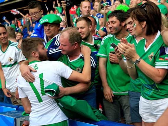 Stuart Dallas speak to his dad after Northern Ireland's defeat to Wales. PA SPORT