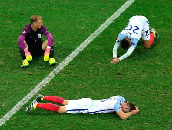 England players lie on the pitch dejected following their European Championship exit