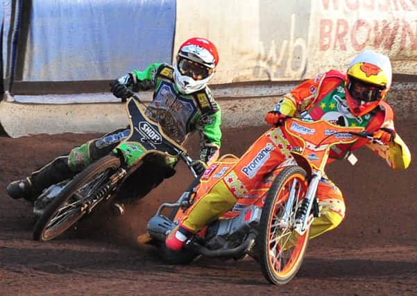 Arthur Sissis (left) looks for a way through on the outside in the Tigers' last meeting with Cradley