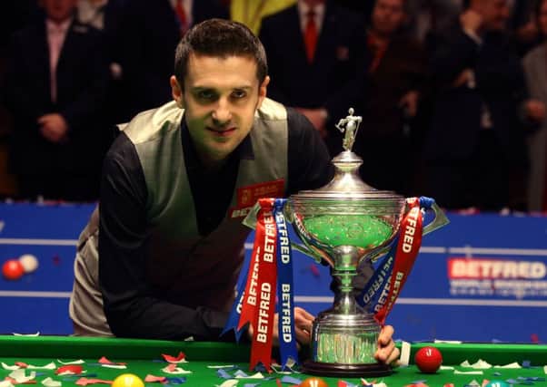 Mark Selby celebrates with the trophy after beating Ding Junhui in the final of the Betfred Snooker World Championships at the Crucible Theatre, Sheffield.
