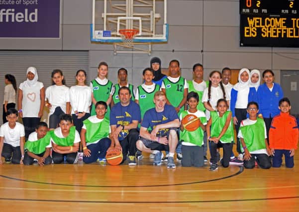 Ariel Parrucci, Sharks Assistant Coach and basketball player Eddy Brownell, pictured with children from Springfield Primary school, during the Respect Basketball Tournament. Picture: Marie Caley NSST Sharks MC 1