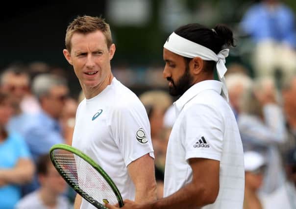 Jonathan Marray (left) and Adil Shamasdin in action in the doubles on day seven of the Wimbledon Championships at the All England Lawn Tennis and Croquet Club, Wimbledon. John Walton/PA Wire.