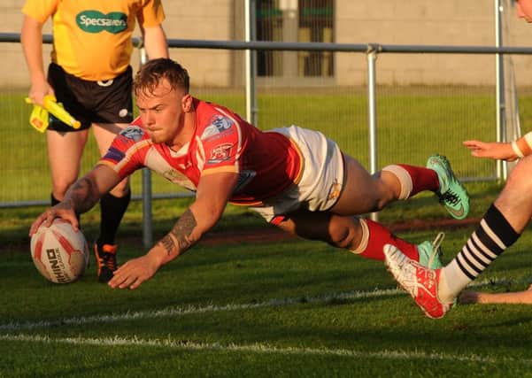 Sheffield Eagles' Ben Blackmore dives over to score a try against Featherstone Rovers. Picture: Andrew Roe