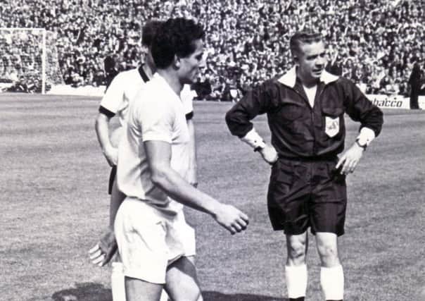 Uruguay captain  Troche, leaves the field after being sent off as referee Jim Finney watches to make sure he leaves the field.