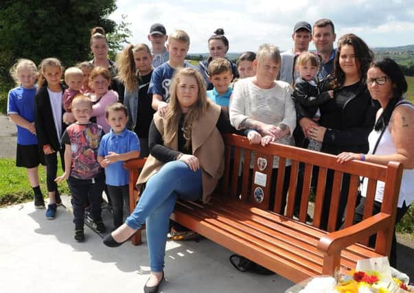 Friends and family gather round a bench in memory of Josh Tyler, who was killed on Mansfield Road, Swallownest. Picture: Andrew Roe