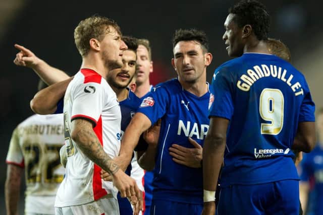 Kyle McFadzean (left) wants to rejoin Sheffield United after submitting a transfer request at MK Dons