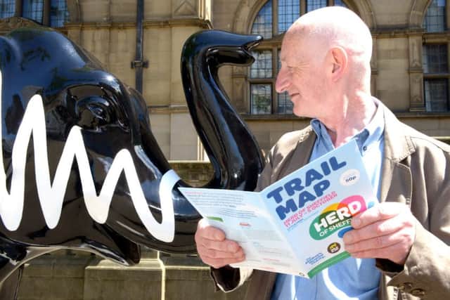 Ex Sheffield United player Tony Currie and Head of Community Mark Todd look at an elephant outside Sheffield United Football Club, which is part of the Herd trail. Picture: Andrew Roe