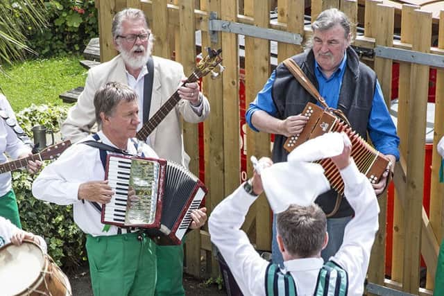 Alec Thompson, Gerry Bates & John Bowden playing at the Hammer & Pincers, with dancer (Dominic Rice) in foreground, in the original kit