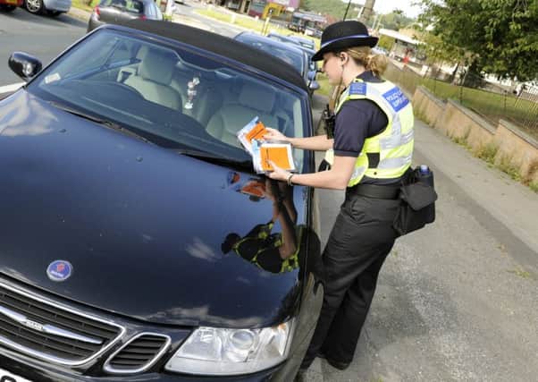 A PCSO warning parents and issuing advice about parking illegally on roads surronding schools, and the dangers it can cause