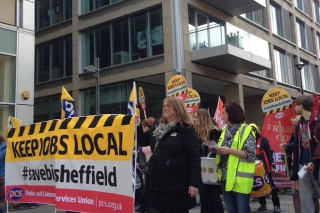 A rally protesting the closure of the BIS department in Sheffield passes the building.