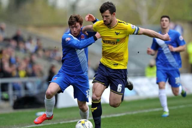 Jake Wright (right) gets the better of an opponent during his time at Oxford United