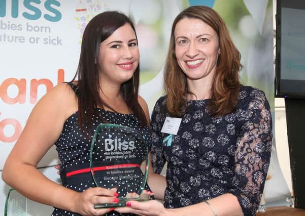 Georgia Melbourne, from Dinnington, receives an award from Bliss chief executive Caroline Davey.