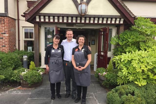 Stewart Dean, manager of Toby Carvery in Dodworth, with two staff members.