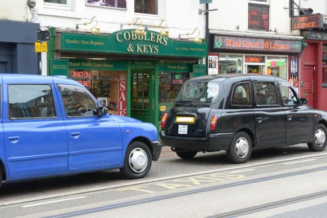 Taxis blocking the view of Cobbler & Keys on West Street in Sheffield city centre has cost the shop Â£300 a week in takings since the lay-by was set up in 2014,  the owner claims