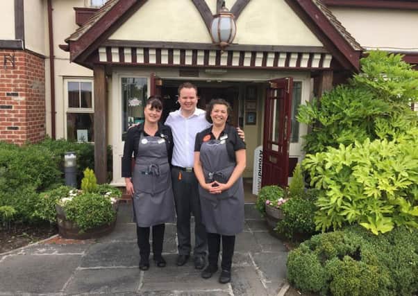 Stewart Dean, manager of Toby Carvery in Dodworth, with two staff members.