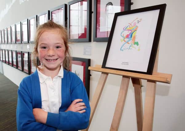 Competition winner Emma Brand from Dore Primary School in Sheffield at the National Football Museum in Manchester where her entry is displayed alongside the work of Paul Trevillion, United Kingdom on 12 July 2016. Photo by Glenn Ashley Photography