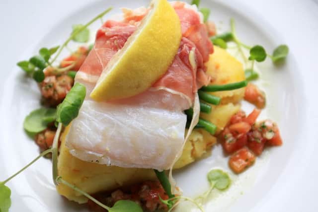Food review at The Millhouses on Abbeydale Road, Sheffield. Pictured is cod loin in parma ham, saffron mash, salsa verde, and green beans. Photo: Chris Etchells