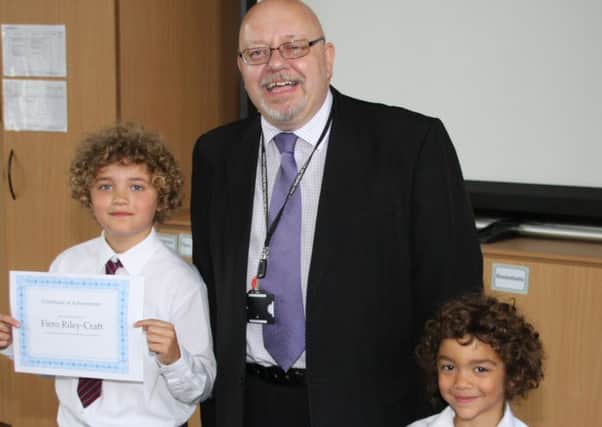 Brothers Fiero Riley-Craft and Leo Riley-Craft, both pupils at Kingfisher Primary School, Doncaster, are presented with certificates from Deputy Mayor Glyn Jones for their involvement with an anti-racism video.