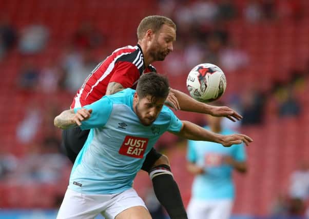 Matt Done  tussles with Jacob Butterfield of Derby County during the pre season friendly at the Bramall Lane