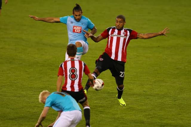 Leon Clarke of Sheffield Utd challenges for the ball during the pre season friendly at Bramall Lane