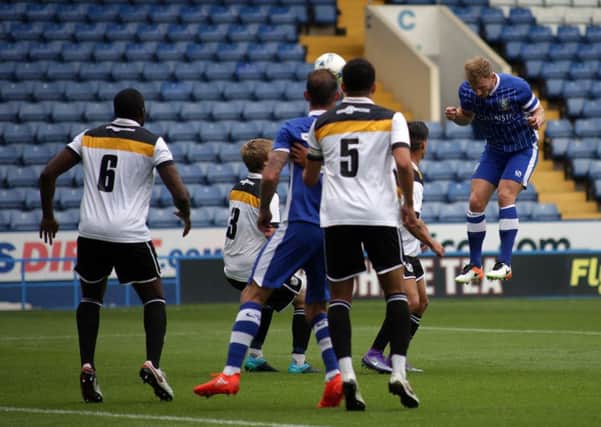 Tom Lees rises to put the Owls in front against Port Vale