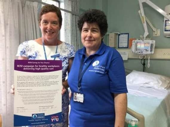 Paula Schofield, head of midwifery at Sheffield Teaching Hospitals, and midwife and RCM health and safety representative Helen Hunt with the charter.