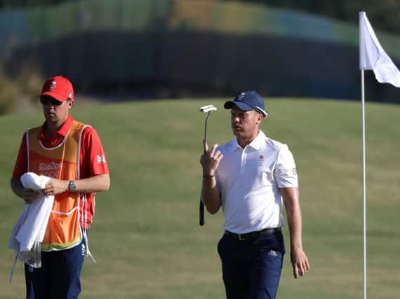 Danny Willett breathes a sigh of frustration as he walks off a green in Rio