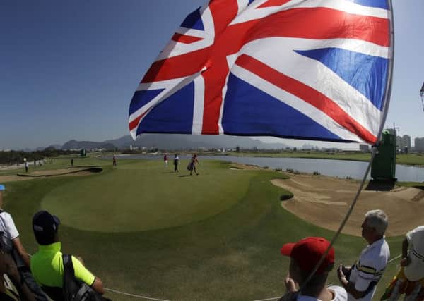 Fans of Great Britain's Danny Willett cheer on the 3rd hole during the final round of the men's golf event at the 2016 Summer Olympics in Rio de Janeiro, Brazil, Sunday, Aug. 14, 2016. (AP Photo/Chris Carlson)