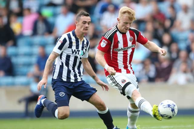 Millwall's Shaun Williams tussles with Sheffield United's Mark Duffy during Saturday's League One match at The Den 
Â©2016 Sport Image all rights reserved