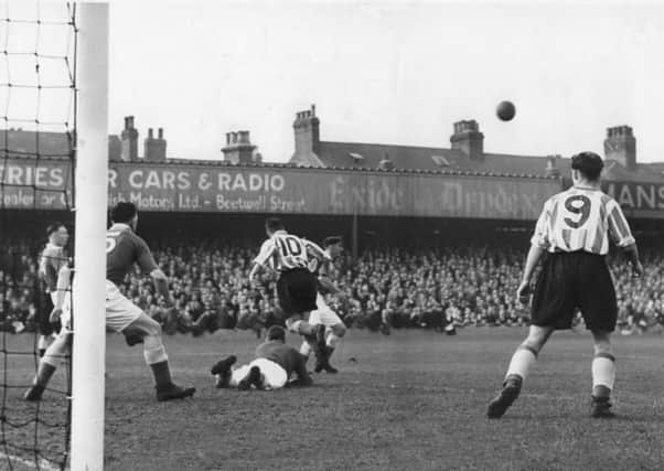 Debutant goalkeeper Bert Lomas has come out to punch away a cross, but half-back Jim Smallwood (partially obscured the Lincoln and future Spireite no. 10, Ernie Whittle) is forced to complete the clearance as Chesterfield defend the Saltergate Kop goal against Lincoln on October 6th, 1951.